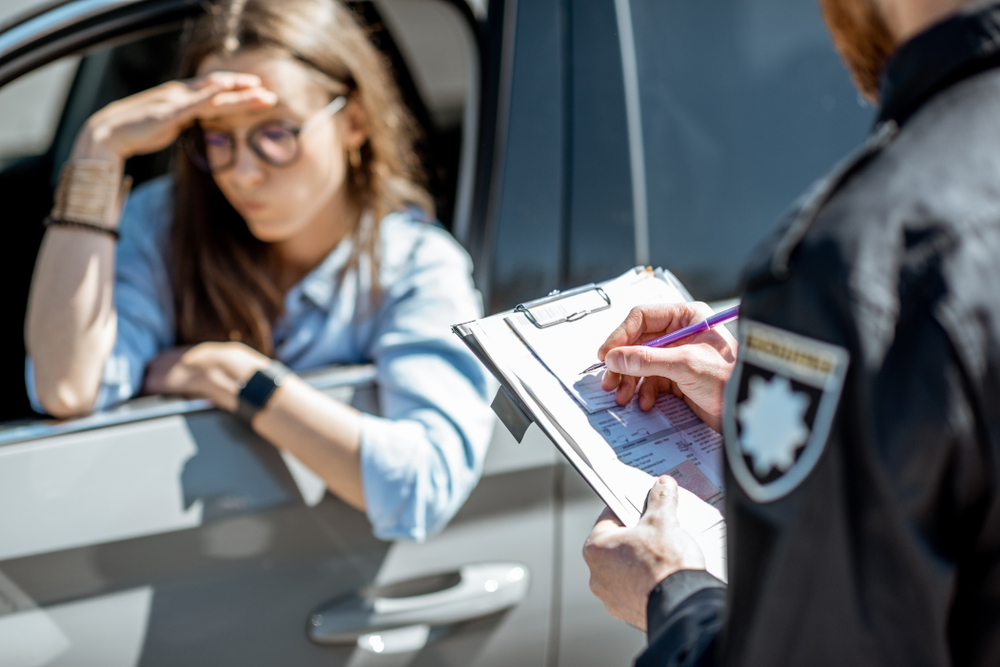 cop writing a female driver a ticket