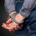 a man with his hands handcuffed behind his back