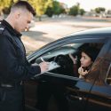 cop writing young woman a traffic ticket